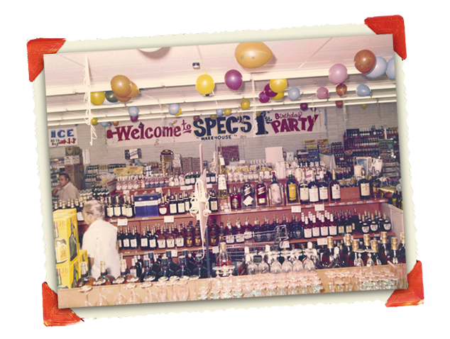 Vintage photograph of store decorated with balloons for Spec's 1st birthday party